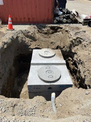 New 1000 gallons traffic rated septic tank installed . With a cast iron traffic lid .