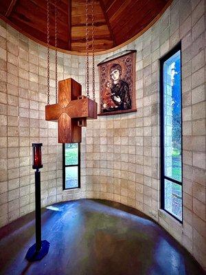 The cross of Jesus and an icon of Virgin Mary holding baby Jesus behind the altar in the St. Cecilia Chapel.