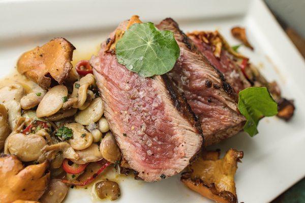 Dry aged strip loin, with field peas, chanterelles