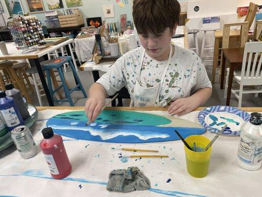 Painting lesson on a surfboard.