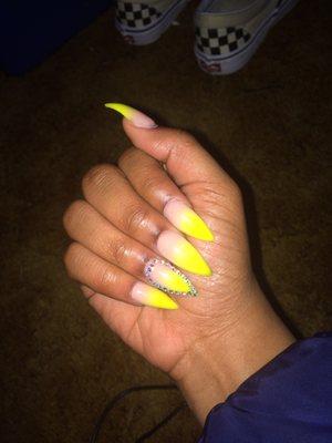 Cover pink and yellow ombré, with a rhinestone outline on ring finger. Topped off with a gel top coat