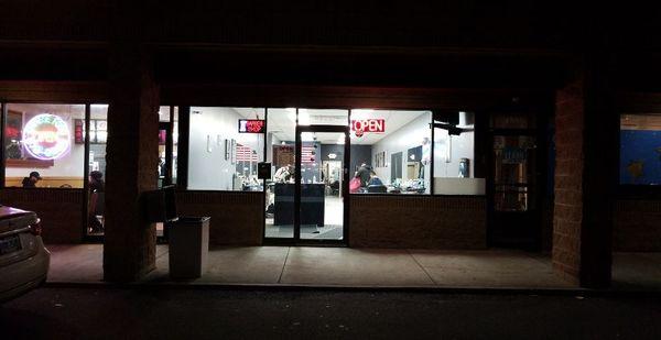 An outside look of the shop at night.