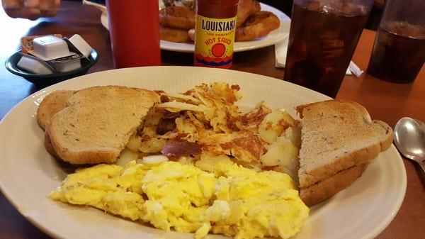 Scrambled eggs  rye butter toast and sliced potatoes. Add some Louisiana hot sauce and yum