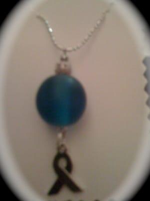 Teal round bead represents the ovary