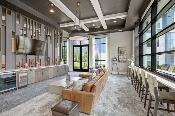 Game room with a billiard table, wet bar and booth-style seating areas at Lantower Garrison Park.