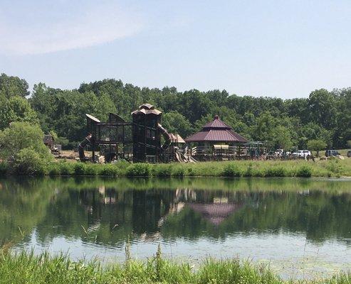 The largest of many playgrounds near a fishing lake.