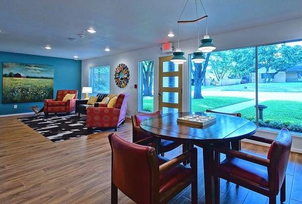 The game table in the foreground with the front entrance and adjacent TV Area beyond