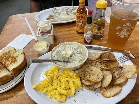 Eggs, grits, potatoes and biscuits in gravy in rear.