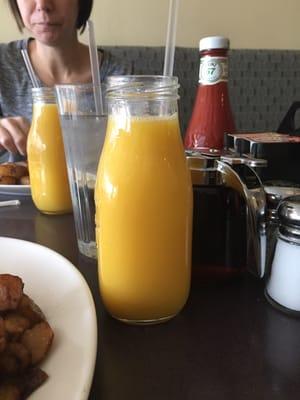 Orange juice in cute milk jugs