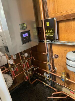 Installation of a new NTI combi boiler system in San Rafael. This system replaces an old cast iron boiler and 40gallon water heater.