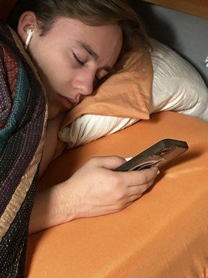 Student studies too hard, sleeps with device in hand