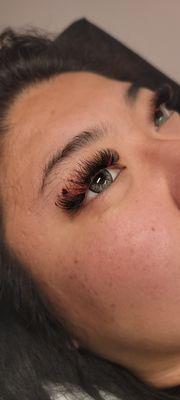 Full volume lash extensions with red extensions and heart charms