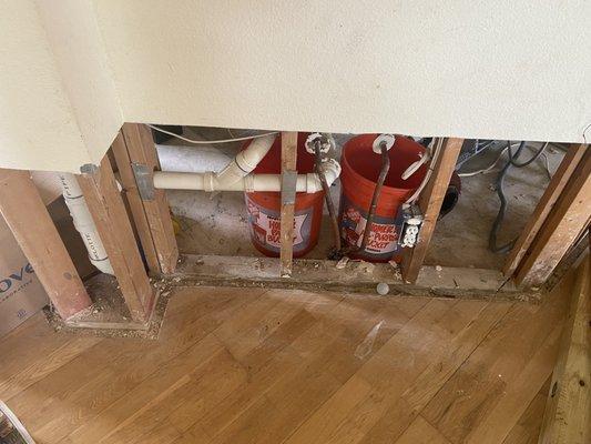 Missing wall, flooring, sink, cupboards where contractors took apart the house to survey the damage.