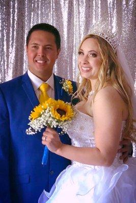 Bride and groom in front of photo area