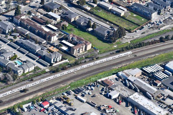 train leaving the depot as seen from the air