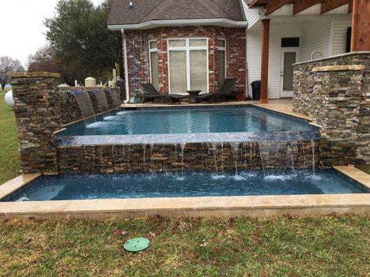 Pool by Blankensteins with light features, custom rock work, and waterfalls.