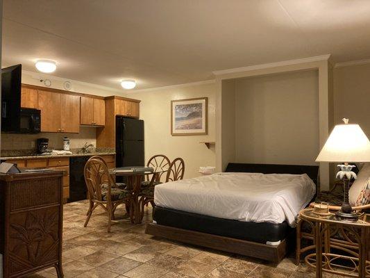 View of the kitchen and dining area. Livingroom furniture moved to display the Murphy bed.