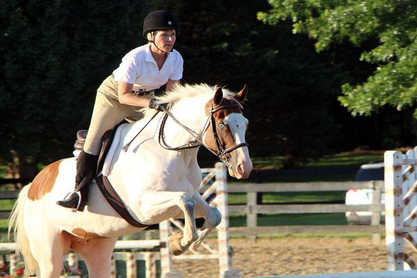 A rider performing stadium jumping during a competition.