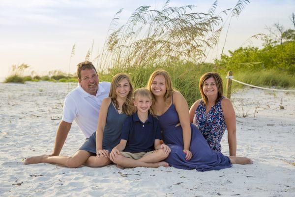 family photos in front of sea oats clearwater beach pictures