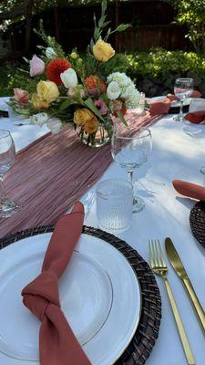 Chargers, dinner plates, silverware, napkins, tablecloths, water glasses, and wine glasses rented for our tablescape