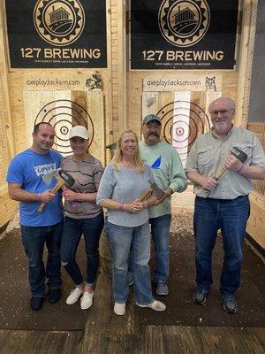 Group of people posing with axes