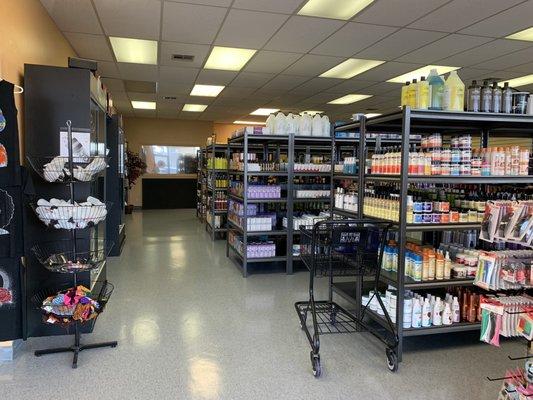 Aisles of products: shampoo, conditioner, setting lotions, jam, etc.