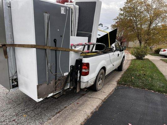 Pickup of a couple refrigerators and shelving