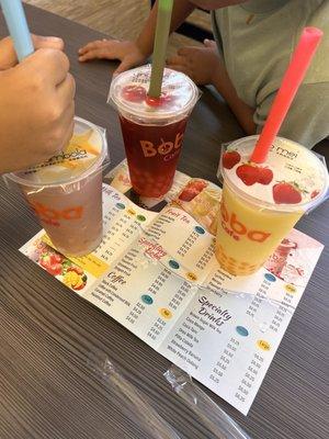 Blueberry smoothie with crystal boba, dragon fruit tea with lychee boba, passion fruit smoothie with passion fruit boba.