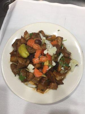 carne de porco a alentejana. fried pork meat small chunks with claims  and pickles