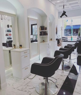 Our beautiful salon after a full gut renovations. You'll find massaging shampoo sinks, marble decor, light and bright interior!