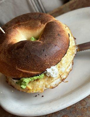 Bagel sandwich with egg and avocado and cream cheese