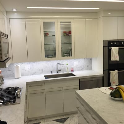 Hi Tech modern kitchen for client who loves to bake in pre-war coop.  Integrated linear ceiling lights...