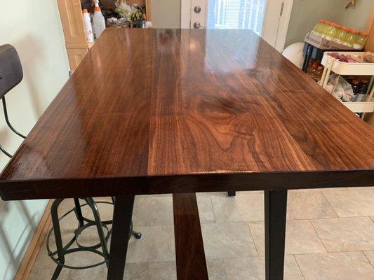 Slab walnut table mounted on powder coated custom welded legs.