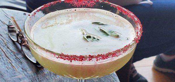 Dried hibiscus flower sugar on a gin, lime & basil martini