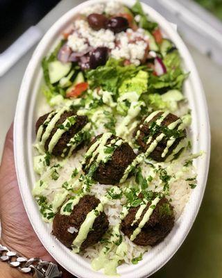 Basmati rice over Falafels, herb sauce and as Greek salad.