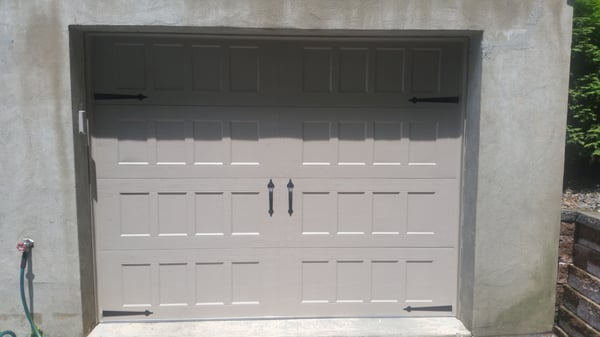 Newly installed insulated garage door with new door openers.