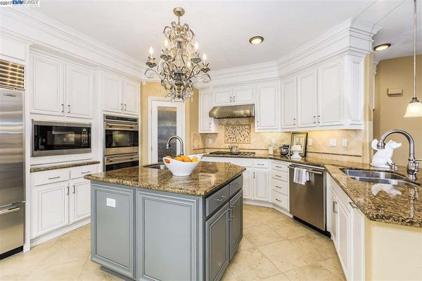 Fresh cabinet finish and new lighting. Note two color cabinet scheme. Counters and flooring untouched