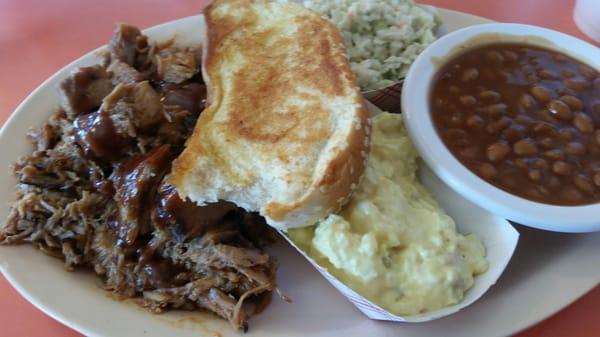 Pork plate with slaw, potato salad, and beans