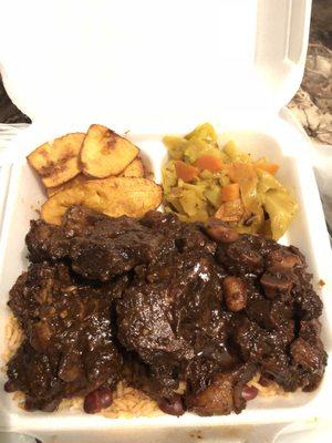 Oxtails, rice and beans, cabbage (has mixed vegetables in them), and plantains. $13.50