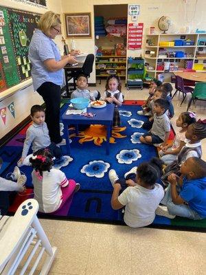 Pre-K class gathered around in learning