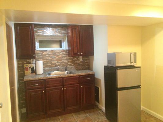 This is the kitchen used to warm and store children's food. It's very clean and the fridge can hold a lot more food than it seems.