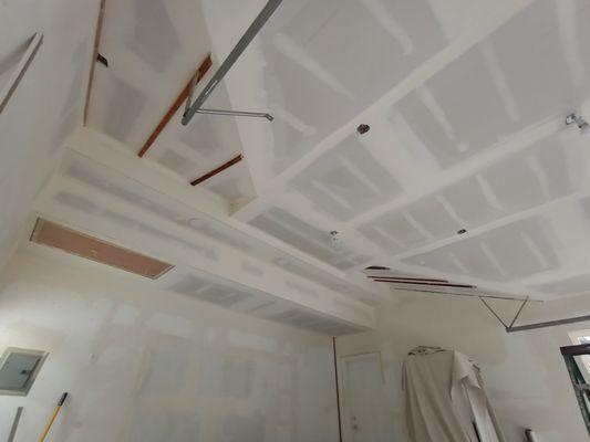 Angled garage ceiling coated smooth