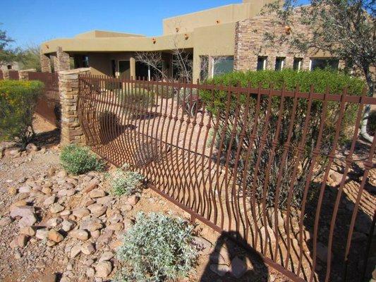 Custom ornamental rustic pot belly iron fence.