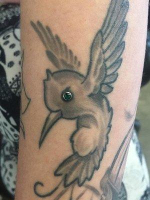 A piercing in a perfect spot of a tattoo. Tattoo done by another amazing artist