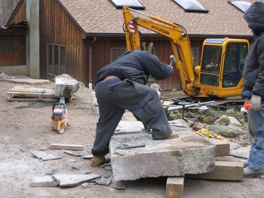 Our skilled stone masons work this large stone platform so it will fit exactly right.