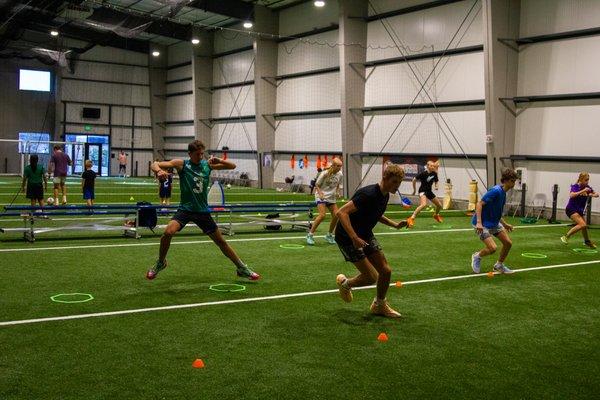 Speed and Agility class and a soccer skills class in the distance using the turf area.