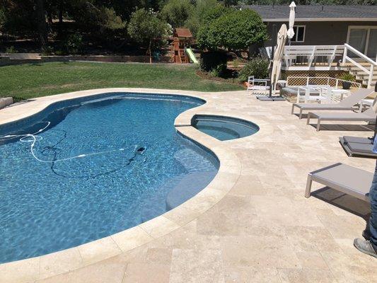 Full polished pebble travertine pavers and coping. Absolutely amazing job.