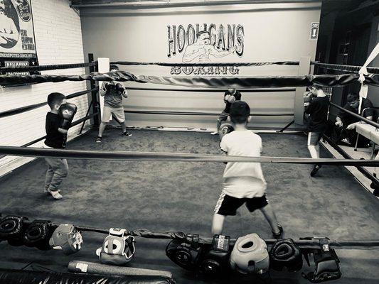 LITTLE CHAMPIONS doing ring work, foot work drills between heavy bag rounds!