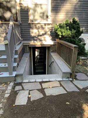 Bluestone steps to basement door with safety railings