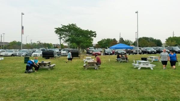 Eating area with park district grills in background